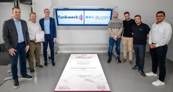 A group photo taken during the presentation of the partner certificate from Funkwerk to Auviso